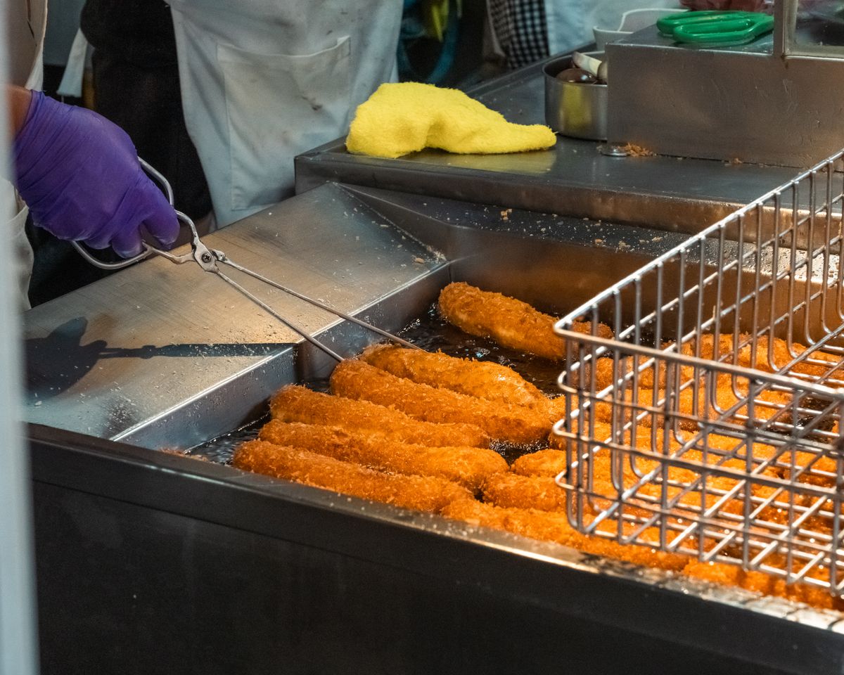 Small air fryer cooking a single serving of crispy fries