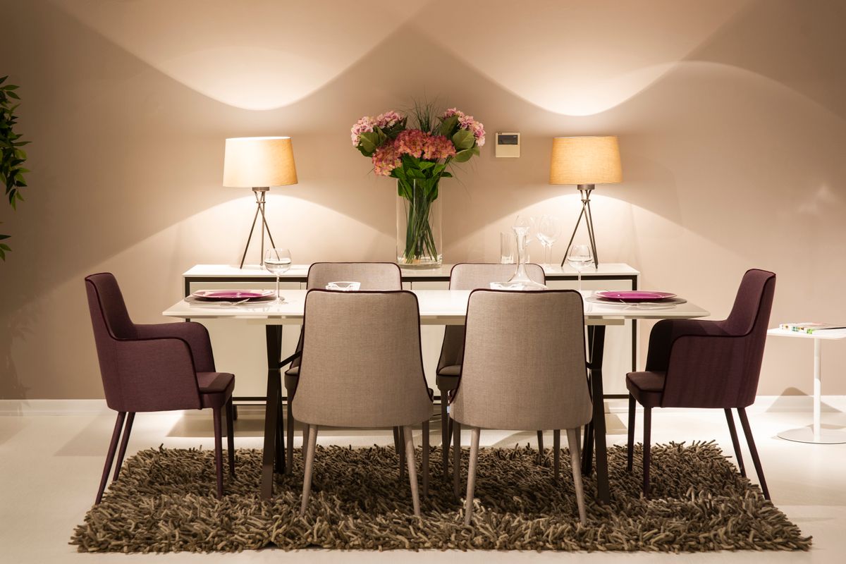 Dining table sized for six in a bright dining room interior