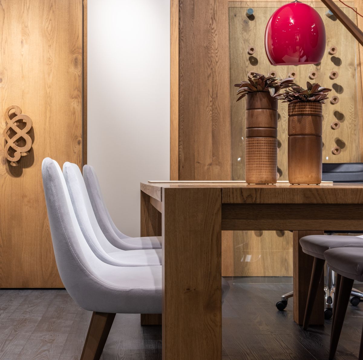 Wooden dining table with chairs showing comfortable place settings