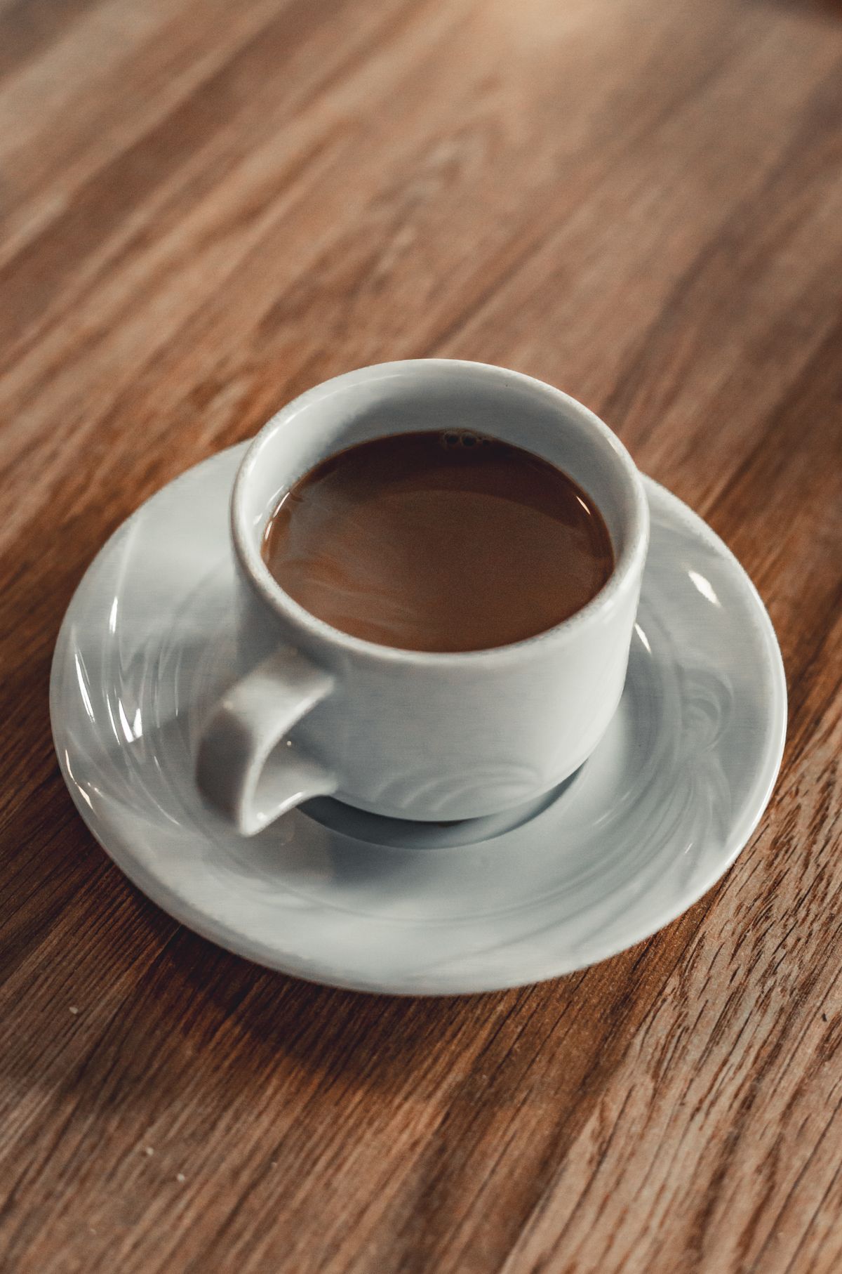 Keurig-style coffee brewer with a travel mug on the drip tray