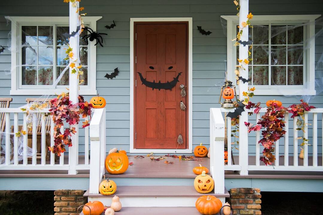 Front porch decorated for Halloween with pumpkins