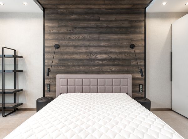 Metal platform bed frame with mattress in a bedroom