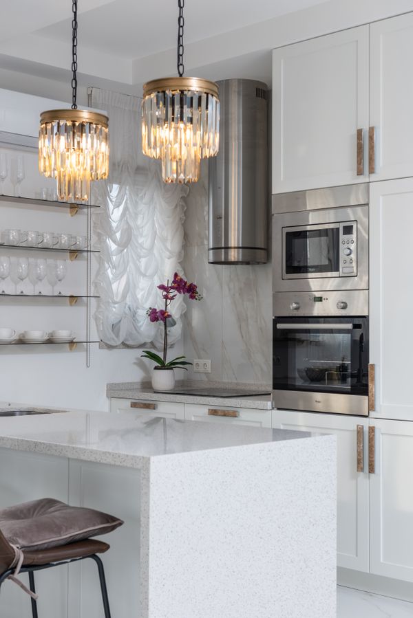 Kitchen island with stylish pendant lamps and bar stools