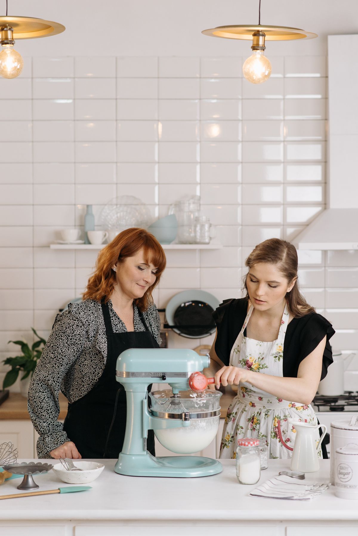 Bowl-lift stand mixer with attachments on a kitchen counter
